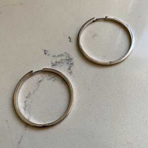 Silver sterling hoops.